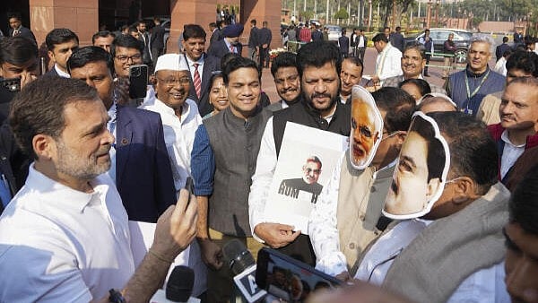 <div class="paragraphs"><p>Leader of Opposition Rahul Gandhi take a mock interview of Congress MPs Manickam Tagore and Saptagiri Sankar Ulaka, wearing face masks of Prime Minister Narendra Modi and Adani Group Chairman Gautam Adani, at a protest demanding a probe into the bribery case in the US involving the billionaire industrialist during the Winter session of Parliament, in New Delhi, Monday, Dec. 9, 2024.</p></div>