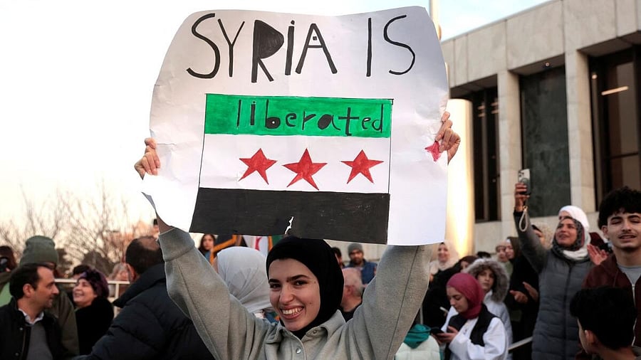 <div class="paragraphs"><p>A woman holds a sign as Syrian-Americans and supporters celebrate after Syrian rebels announced that they have ousted President Bashar al-Assad in Syria, in Dearborn, Michigan, US December 8, 2024.</p></div>