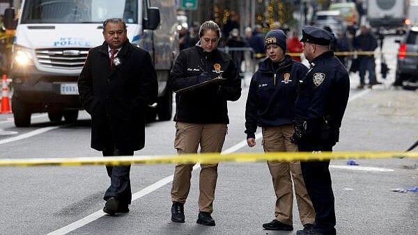 <div class="paragraphs"><p>Police officers work near the scene where the CEO of UnitedHealthcare Brian Thompson was reportedly shot and killed in Midtown Manhattan, in New York City.</p></div>