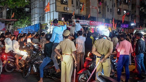 <div class="paragraphs"><p>Police personnel stand guard after tension arisen between two groups over the Ayodhya's Ram Temple event, in Mumbai, Tuesday, Jan. 23, 2024. Earlier today, local administration carried out a demolition drive against alleged illegal structures built on a roadside at Mira Road. Clashes broke out in the area Monday during Ram Mandir consecration.</p></div>
