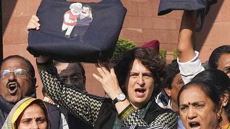 <div class="paragraphs"><p>Congress MP Priyanka Gandhi Vadra with other I.N.D.I.A. bloc MPs stages a protest over indictment of industrialist Gautam Adani by a US court in a bribery case, during the Winter session of Parliament, in New Delhi, Tuesday. </p></div>