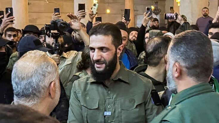 <div class="paragraphs"><p>Top rebel commander Abu Mohammed al-Golani greets a man at Ummayad Mosque in Damascus.</p></div>