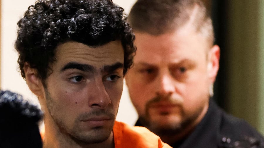 <div class="paragraphs"><p>Luigi Mangione, 26, a suspect in the New York City killing of UnitedHealth executive Brian Thompson, is escorted after an extradition hearing at Blair County Court House in Hollidaysburg, Pennsylvania, U.S. December 10, 2024.</p></div>
