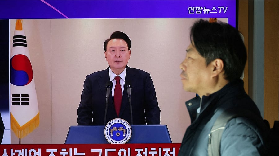 <div class="paragraphs"><p>A person stands by a TV screen broadcasting South Korean President Yoon Suk Yeol delivering an address to the nation, at a railway station in Seoul, South Korea.</p></div>