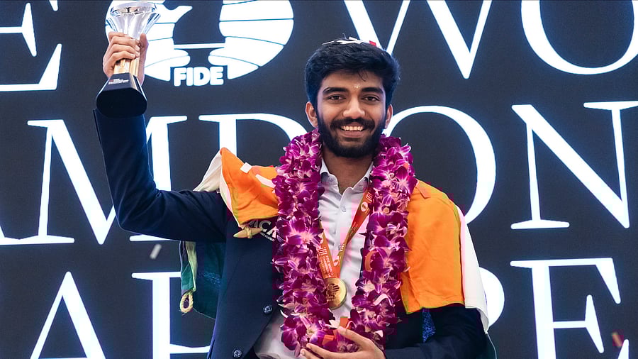 <div class="paragraphs"><p>D Gukesh holds aloft the World Chess Championship trophy in Singapore on Friday. </p></div>
