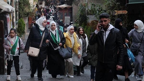 <div class="paragraphs"><p>People walk at a traditional souq in the Bab Touma district of the Old City of Damascus, after fighters of the ruling Syrian body ousted Syria's Bashar al-Assad, in Damascus, Syria, December 14, 2024.</p></div>