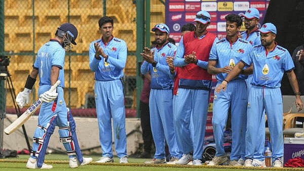 <div class="paragraphs"><p>Mumbai's Ajinkya Rahane, left, being greeted by teammates at the dugout as he walks off the field</p></div>