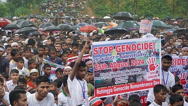 <div class="paragraphs"><p>Rohingya refugees gather to mark the seventh anniversary of their fleeing from neighbouring Myanmar to escape a military crackdown in 2017, during heavy monsoon rains in Cox's Bazar, Bangladesh.</p></div>