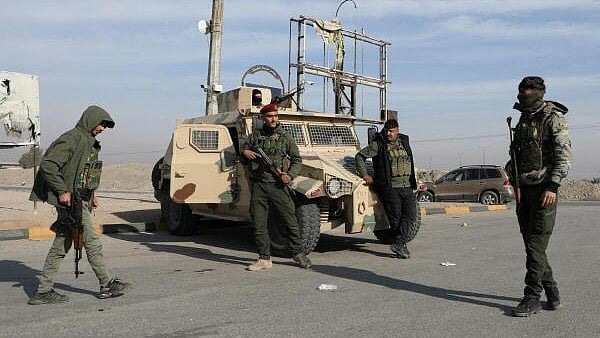 <div class="paragraphs"><p>Members of Kurdish-led Syrian Democratic Forces (SDF) stand along a street, after rebels seized the capital and ousted Syria's Bashar al-Assad, in Hasakah, Syria.</p></div>