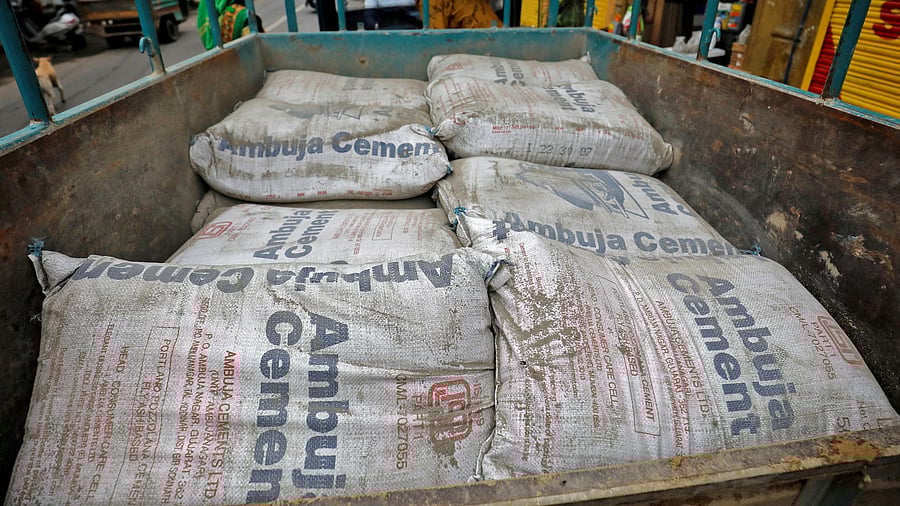 <div class="paragraphs"><p>A representative image of shows Ambuja Cement bags being carried to a construction site.</p></div>