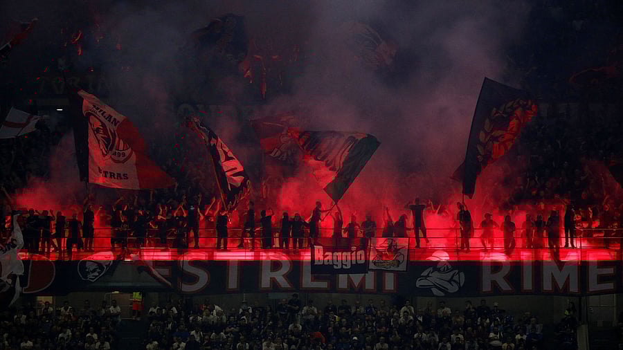 <div class="paragraphs"><p>AC Milan fans with flares during a match.</p></div>