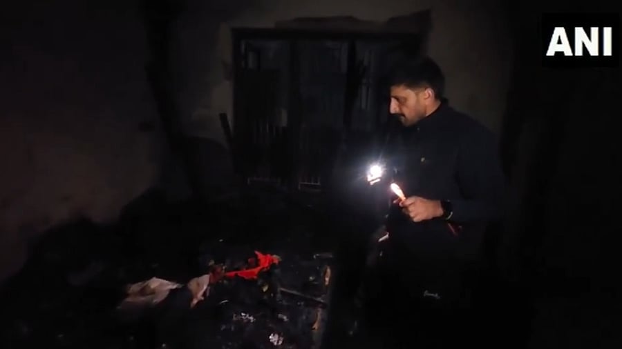 <div class="paragraphs"><p>Officials examine the burnt-down house.</p></div>