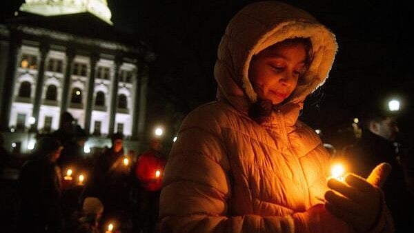 <div class="paragraphs"><p>Mourners gather for a candlelight vigil at the Wisconsin State Capitol building a day after a shooting at Abundant Life Christian School, in Madison, Wisconsin, US.</p></div>