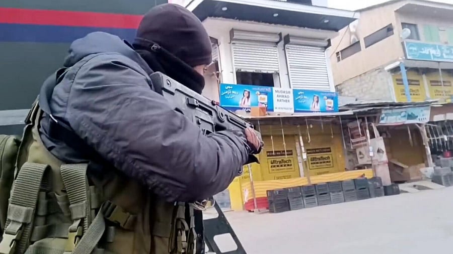 <div class="paragraphs"><p>A security personnel takes position during an encounter with terrorists at Kadder in the Behibagh area of Kulgam district, J&amp;K</p></div>