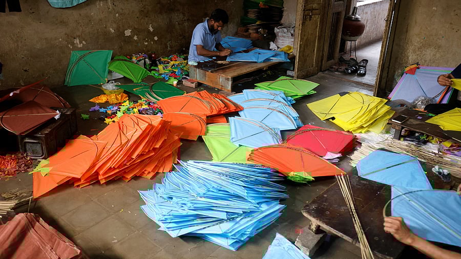 <div class="paragraphs"><p>Men make kites inside a house in Ahmedabad, India, December 5, 2023. </p></div>