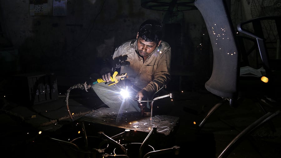 <div class="paragraphs"><p>A worker welds an iron table stand at a workshop in Mumbai.</p></div>