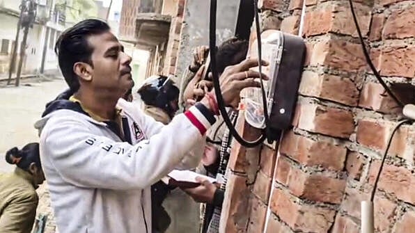 <div class="paragraphs"><p>An officer checks electricity reading at the residence of Samajwadi Party MP Ziaur Rehman Barq, in Sambhal, Uttar Pradesh, Thursday, Dec. 19, 2024. Barq was booked by the Uttar Pradesh Police on Thursday for alleged theft of electricity at his residence in the Deepa Sarai neighbourhood in Sambhal.</p></div>