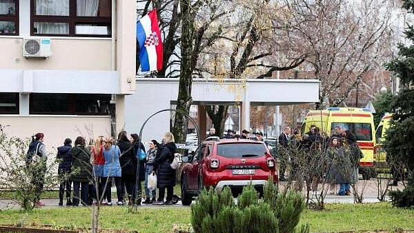 <div class="paragraphs"><p>People stand near an ambulance, following a knife attack in a primary school, in Zagreb, Croatia.</p></div>