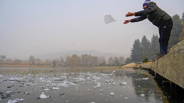 <div class="paragraphs"><p>A man throws pieces of ice in a frozen water body on a cold day, in Srinagar, Thursday, Dec. 19, 2024. The city recorded a minimum temperature of minus 6 degree Celsius.</p></div>