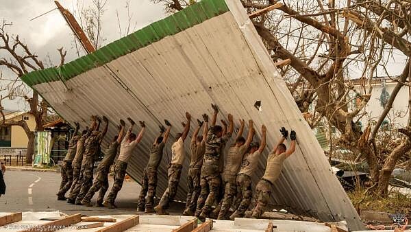 <div class="paragraphs"><p>French soldiers work to clear a road in the aftermath of Cyclone Chido, in Mayotte, France.</p></div>