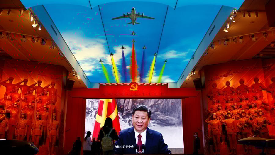 <div class="paragraphs"><p>Visitors stand in front of a giant screen displaying Chinese President Xi Jinping next to a flag of the Communist Party of China, at the Military Museum of the Chinese People's Revolution in Beijing. For representational purposes.</p></div>