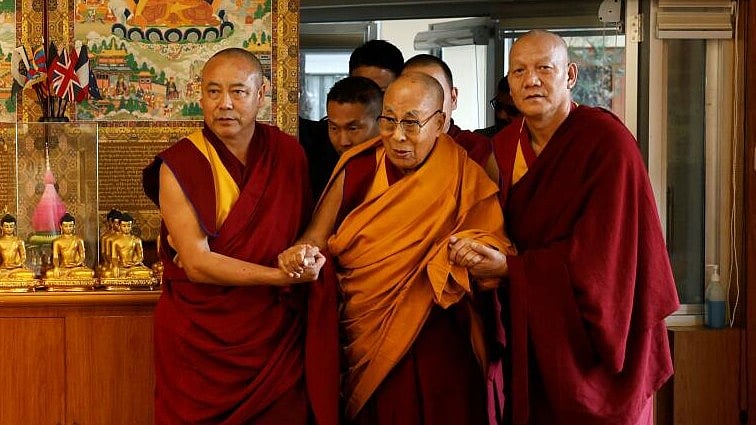 <div class="paragraphs"><p>Tibetan spiritual leader, the Dalai Lama, is escorted into a hall by monks holding his hands at his Himalayan residence in Dharamshala, India.</p></div>