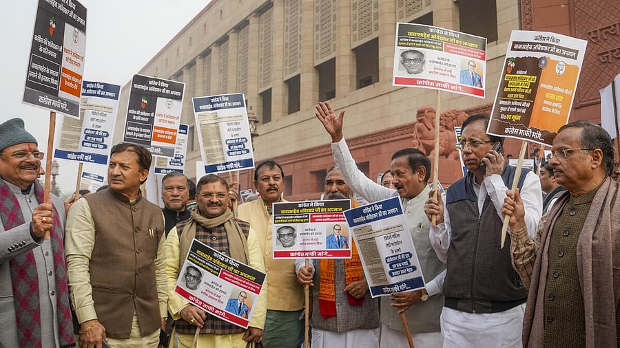 <div class="paragraphs"><p>BJP MPs stage a protest alleging insult of Dr BR Ambedkar by the Congress party, at Parliament complex, in New Delhi</p></div>