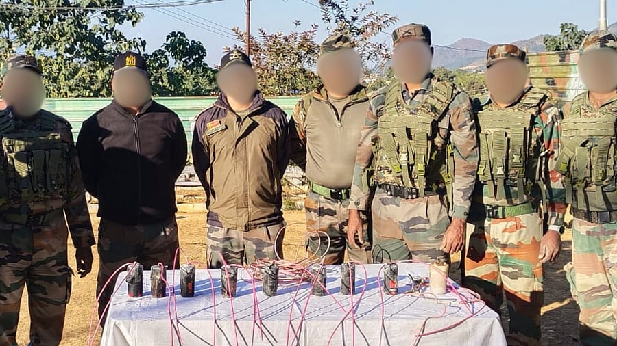 <div class="paragraphs"><p>Officers with the recovered explosives. </p></div>