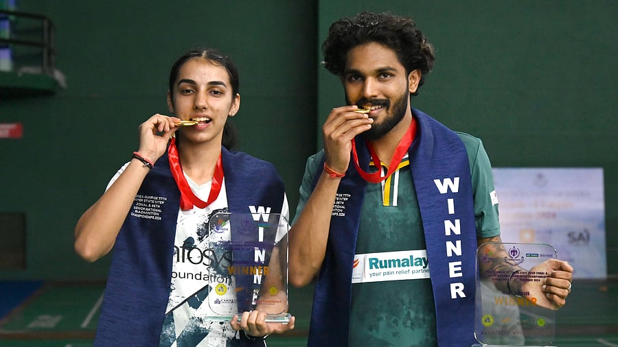 Winners of the 86th Senior National Badminton Championships - Devika Sihag (left) and Raghu M - pose with their spoils. DH PHOTO/ Kishore Kumar Bolar