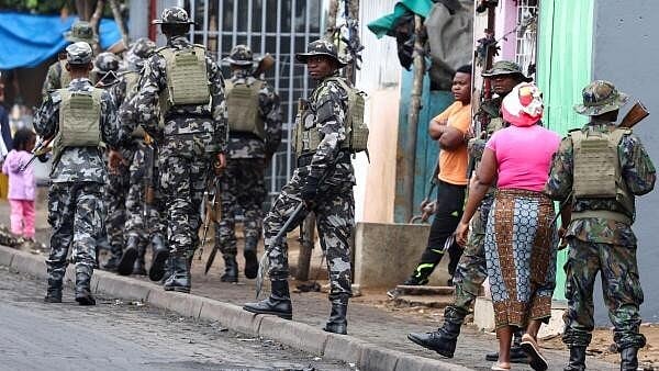 <div class="paragraphs"><p>A member of the Mozambique military, looks on as they patrol the streets of the capital as protests rock Mozambique</p></div>