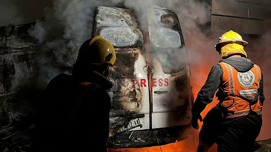 <div class="paragraphs"><p>Civil Defense members put out a fire in a broadcast van following an Israeli strike that killed five journalists of Al-Quds Al-Youm television channel, according to medics with the Gaza health authorities, in the vicinity of Al-Awda hospital in Nuseirat in central Gaza December 26, 2024. </p></div>