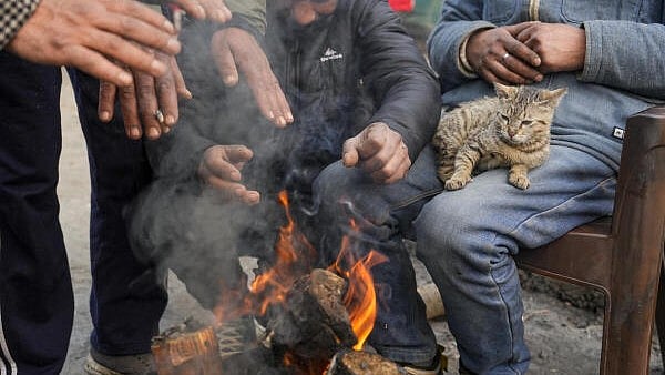 <div class="paragraphs"><p>Boatmen warm themselves on a cold winter day, at the Dal Lake in Srinagar</p></div>