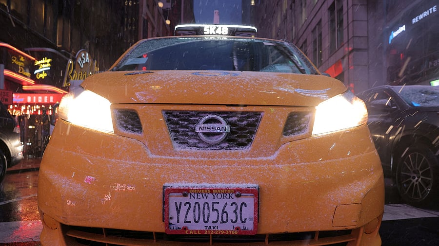 <div class="paragraphs"><p>Snow falls on a taxi cab.</p></div>