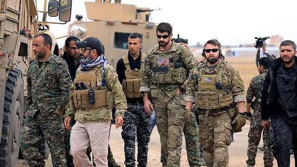 <div class="paragraphs"><p>Syrian Democratic Forces and US troops are seen during a patrol near Turkish border in Hasakah, Syria.</p></div>