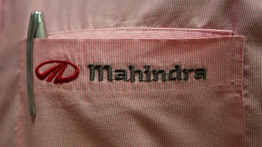 <div class="paragraphs"><p>The logo of Mahindra &amp; Mahindra Ltd is pictured on the pocket of a salesman's shirt.</p></div>