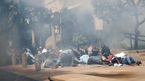 <div class="paragraphs"><p>Protesters demonstrating against what they say is a wave of unexplained abductions of government critics, react after riot police lobbed teargas canisters to disperse them along the Aga Khan walk in downtown Nairobi, Kenya.&nbsp;</p></div>