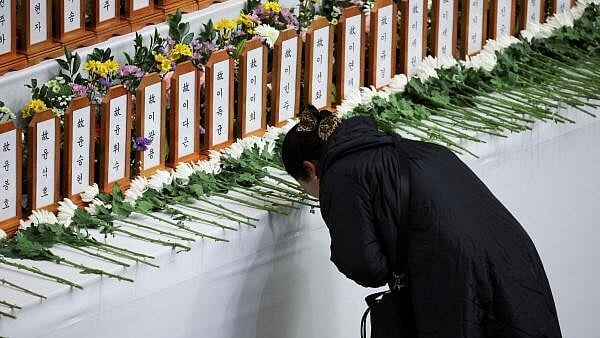 <div class="paragraphs"><p>A woman prays at a memorial altar for the victims of the Jeju Air crash at Muan International Airport, at Muan Sports Park in Muan, South Korea. Representational purpose. </p></div>