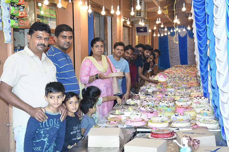<div class="paragraphs"><p>People throng to buy cakes on display at a bakery in Chikkaballapur on Tuesday.</p></div>