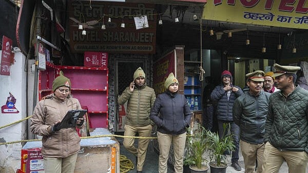 <div class="paragraphs"><p>Police personnel during an investigation after five members of a family were found dead at a hotel</p></div>