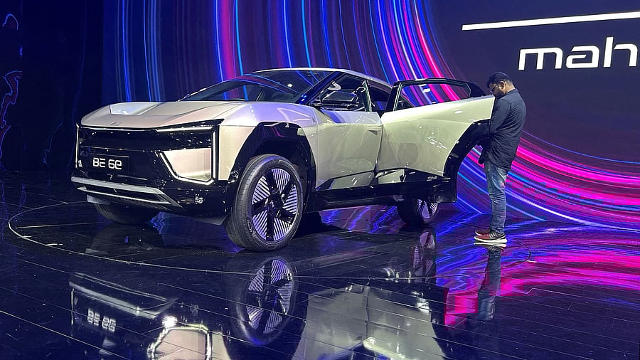 <div class="paragraphs"><p>A man films the interiors  Mahindra BE 6e, an electric SUV car, during its launch.</p></div>
