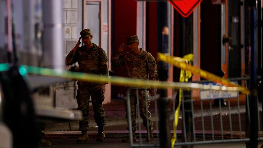 <div class="paragraphs"><p>Military personnel gesture as they walk near the site where people were killed by a man driving a truck in an attack during New Year's celebrations, in New Orleans, Louisiana, US, January 1, 2025.</p></div>