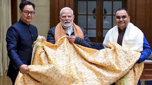 <div class="paragraphs"><p>Prime Minister Narendra Modi with Union Minister Kiren Rijiju presents the 'chadar' which was offered on his behalf at the Ajmer Sharif Dargah on the Urs of Khwaja Moinuddin Chishti.</p></div>