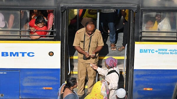 <div class="paragraphs"><p>Commuters board BMTC buses at KR Market bus stop in Bengaluru.&nbsp;</p></div>