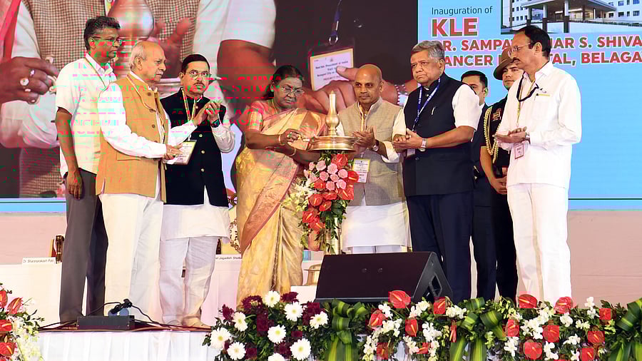 President Draupadi Murmu lights the lamp to inaugurate the Dr Sampatkumar S Shivanagi cancer hospital of the KLE Society in Belagavi on Friday. Public Works Minister Satish Jarkiholi, KLE society chairman Prabhakar Kore, Union Minister Pralhad Joshi, Medical Education Minister Sharanprakash Patil, Belgaum MP Jagadish Shettar and others are seen.