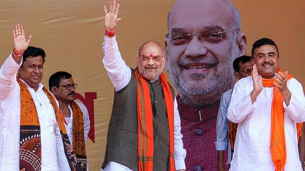 <div class="paragraphs"><p>Union Home Minister Amit Shah with BJP WB President Sukanta Majumdar and party leader Suvendu Adhikari during a public meeting at Suri in Birbhum district. </p></div>