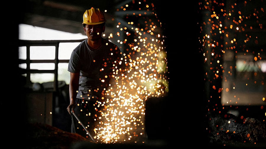 <div class="paragraphs"><p>An employee works at a steel processing production line of a factory.</p></div>