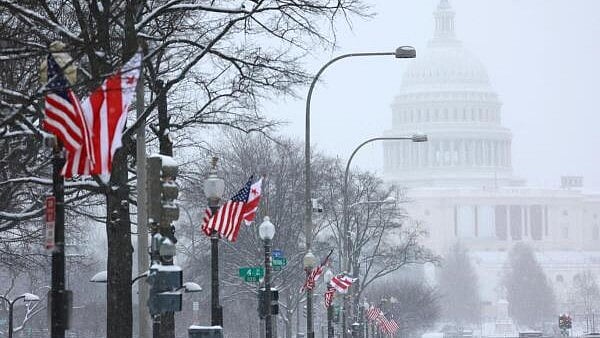 <div class="paragraphs"><p>Flags flutter with the US Capitol building in distance, as a winter storm that brought snow, ice and freezing temperatures to a broad swath of the US hits Washington.&nbsp;</p></div>