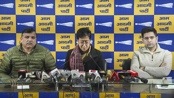 <div class="paragraphs"><p>Delhi Chief Minister Atishi reacts as AAP leaders Sanjay Singh and Raghav Chadha look on during a press conference.&nbsp;</p></div>
