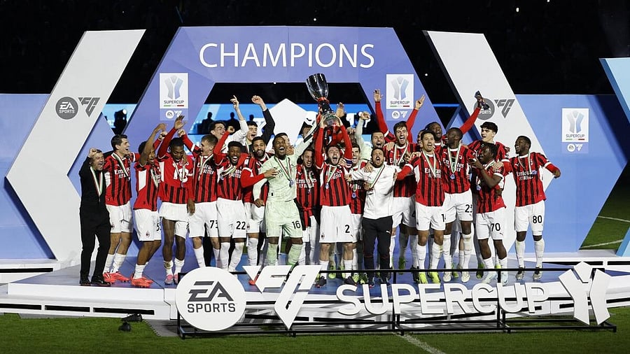 <div class="paragraphs"><p>AC Milan's Davide Calabria lifts the trophy as he celebrates with teammates after winning the Italian Super Cup.</p></div>