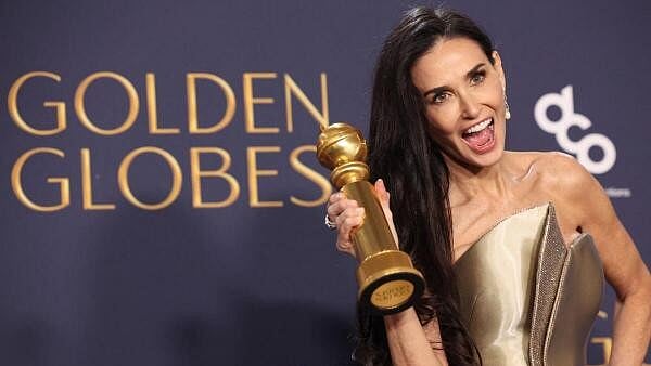 <div class="paragraphs"><p>Demi Moore poses with the award.</p></div>